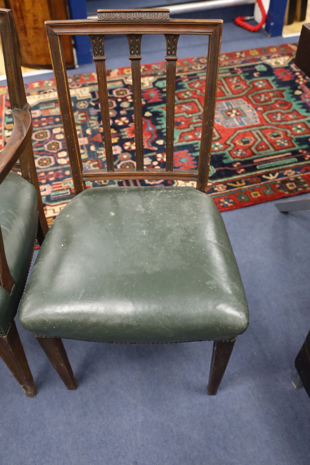 A set of six Hepplewhite style mahogany chairs (two with arms)